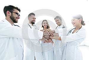 Doctors and nurses in a medical team stacking hands