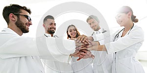 Doctors and nurses in a medical team stacking hands