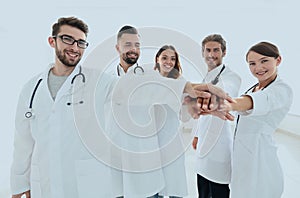 Doctors and nurses in a medical team stacking hands