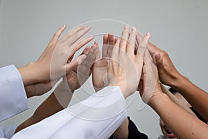 Doctors and nurses in a medical team stacking hands