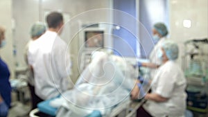 Doctors and nurses performing endoscopic procedure in hospital