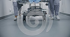 Doctors and nurses push stretcher with patient