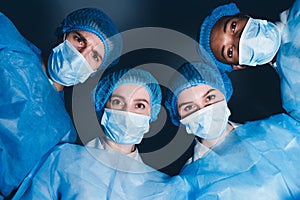 Doctors In Operation Theater Looking At Patient