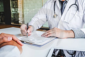 Doctors and patients consulting and diagnostic examining sit and talk. At the table near the window in the hospital medicine