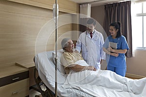 Doctors and physical therapists are caring for elderly sick people. Doctor and nurse taking care of elderly patient on the bed at