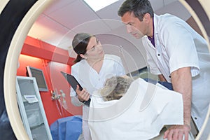 Doctors preparing patient for mri scan in hospital