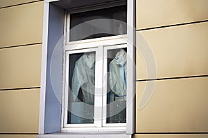 Doctors' protective suits against Covid-19 hang on a window in a closed sector of the hospital.