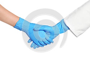 Doctors shacking hands in medical gloves