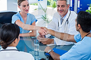 Doctors shaking hands during a meeting