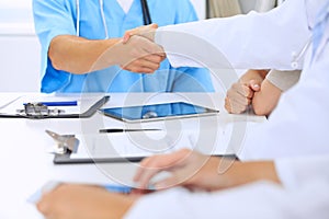 Doctors shaking hands to each other finishing up medical meeting