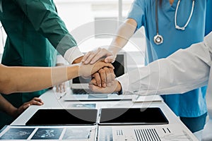 Doctors shaking hands, working together as a team at the hospital