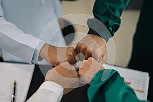 Doctors shaking hands, working together as a team at the hospital