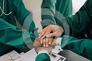 Doctors shaking hands, working together as a team at the hospital