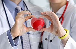 Doctors showing heart symbol