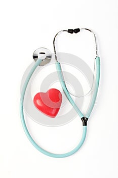 Doctors stethoscope and one red heart on white background