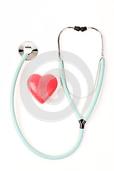 Doctors stethoscope and one red heart on white background