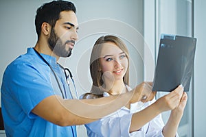 Doctors team examining a patient`s x-ray