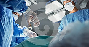 Doctors, team and scissors in theater for surgery, healthcare or medical support and operation room at hospital. Surgeon