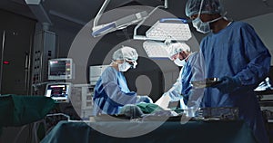 Doctors, team and surgery in theater with medical support for healthcare, safety and operation room at hospital. Surgeon