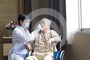 Doctors are testing the virus from elderly people. A doctor in protective clothing is testing a patient`s virus in a hospital