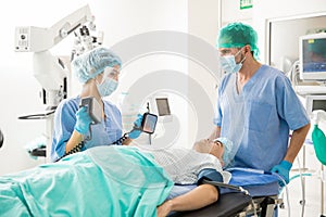 Doctors using defibrillator on patient