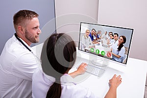 Doctors Video Chatting On Computer