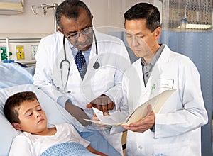 Doctors Visiting Child Patient On Ward