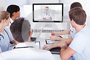 Doctors watching online presentation