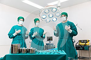 Doctors are wearing protective gloves, examining and treating patients in operating room equipped with modern medical equipment