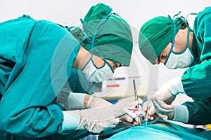 Doctors are wearing protective gloves, examining and treating patients in operating room equipped with modern medical equipment