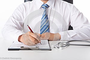 Doctor working with medical statistics and financial reports in office