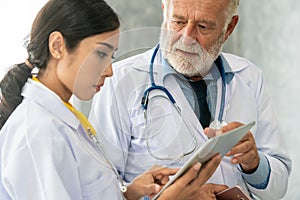 Doctors working with tablet computer at hospital.