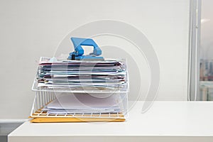 Document in documents tray with paper punch on the white table at the office area