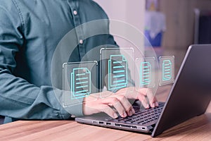 Document management concept with icons on ERP virtual screen. Employee typing on a computer keyboard checking documents in office