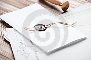 Document with notary seal and papers on wooden table