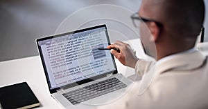 Document Proofreading: African American Man Editing Script Online Spelling