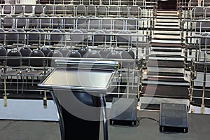 Document stand on stage and rows of chairs with