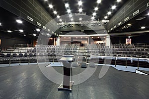 Document stand on stage and rows of chairs with