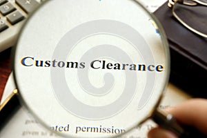 Document with title Customs Clearance on a table.