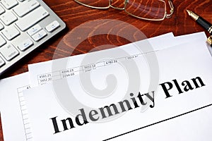 Document with title Indemnity Plan on a table.