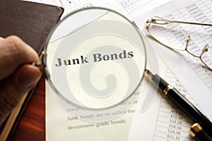 Document with title junk bond on a table.