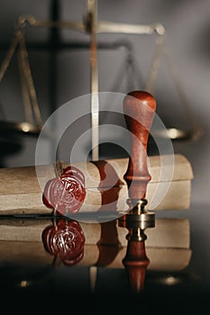 Document with wax seal, scales and antique stamp on a desk. Last will and legacy concept