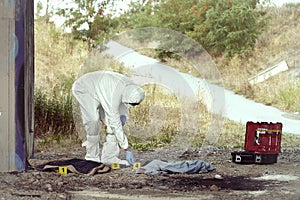 Documentation of suspicious evidences by technician in terrain photo