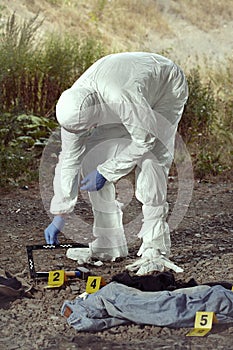 Documentation of suspicious evidences by technician in terrain photo