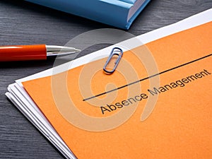 Documents about absence management and notepad. photo