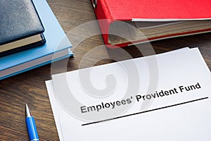 Documents about Employees Provident Fund and red folder. photo