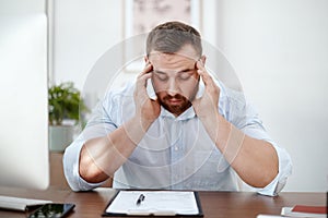 Documents, headache and business man in office with career burnout, mental health risk and paperwork. Brain fog, problem