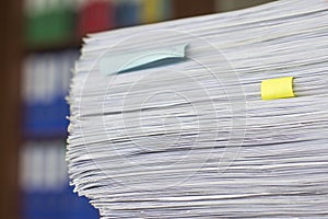 Documents in large quantities are on the table. archived paper reports