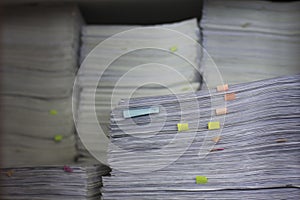 Documents in large quantities are on the table. archived paper reports