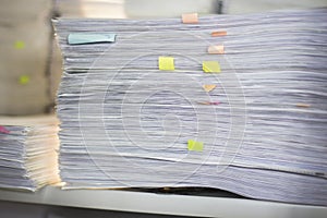 Documents in large quantities are on the table. archived paper reports